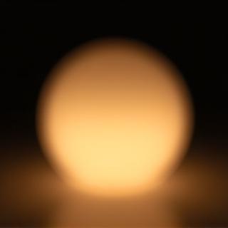 Frosted glass calming light orb radiating soft, warm light